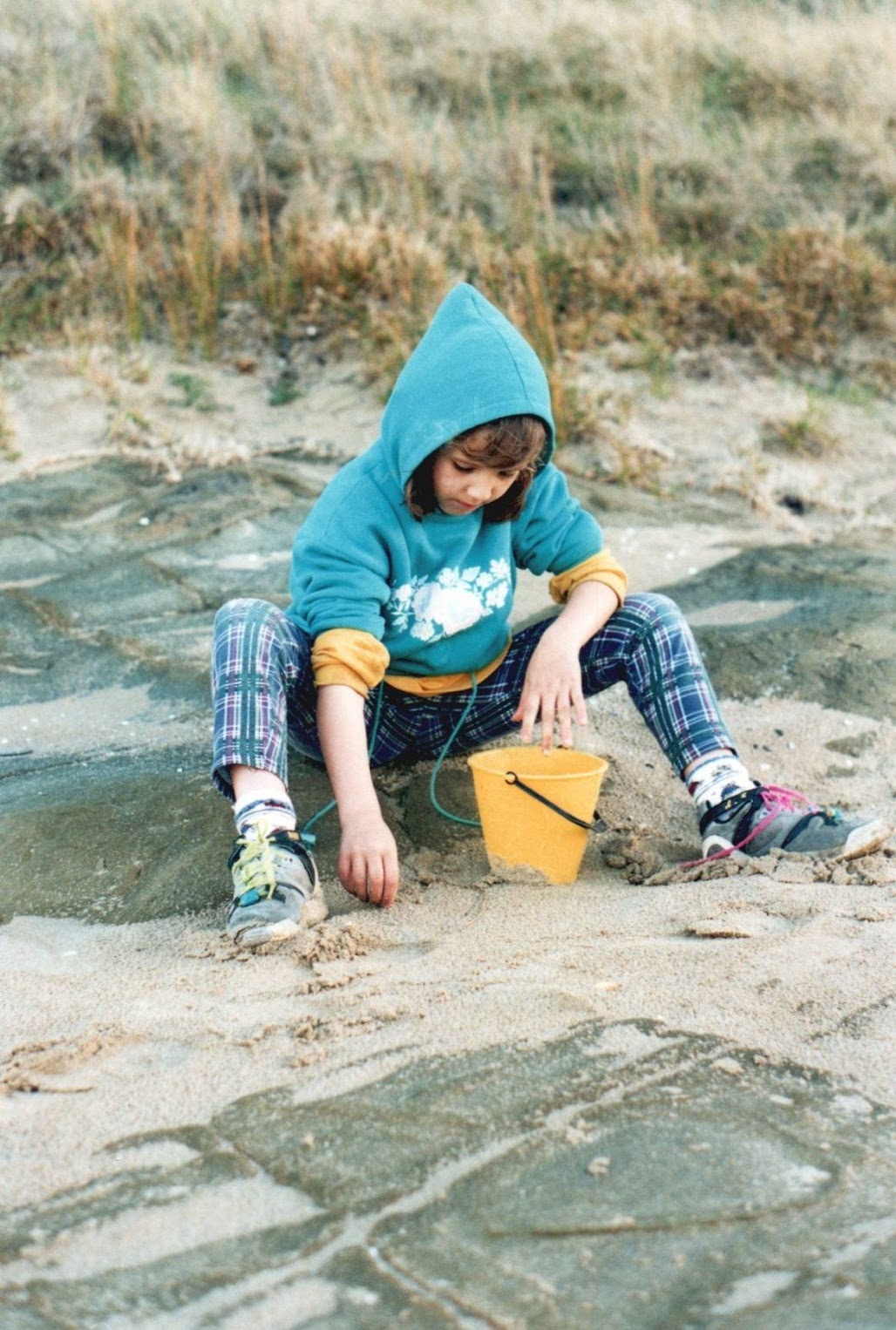 Young Caity playing on the beach