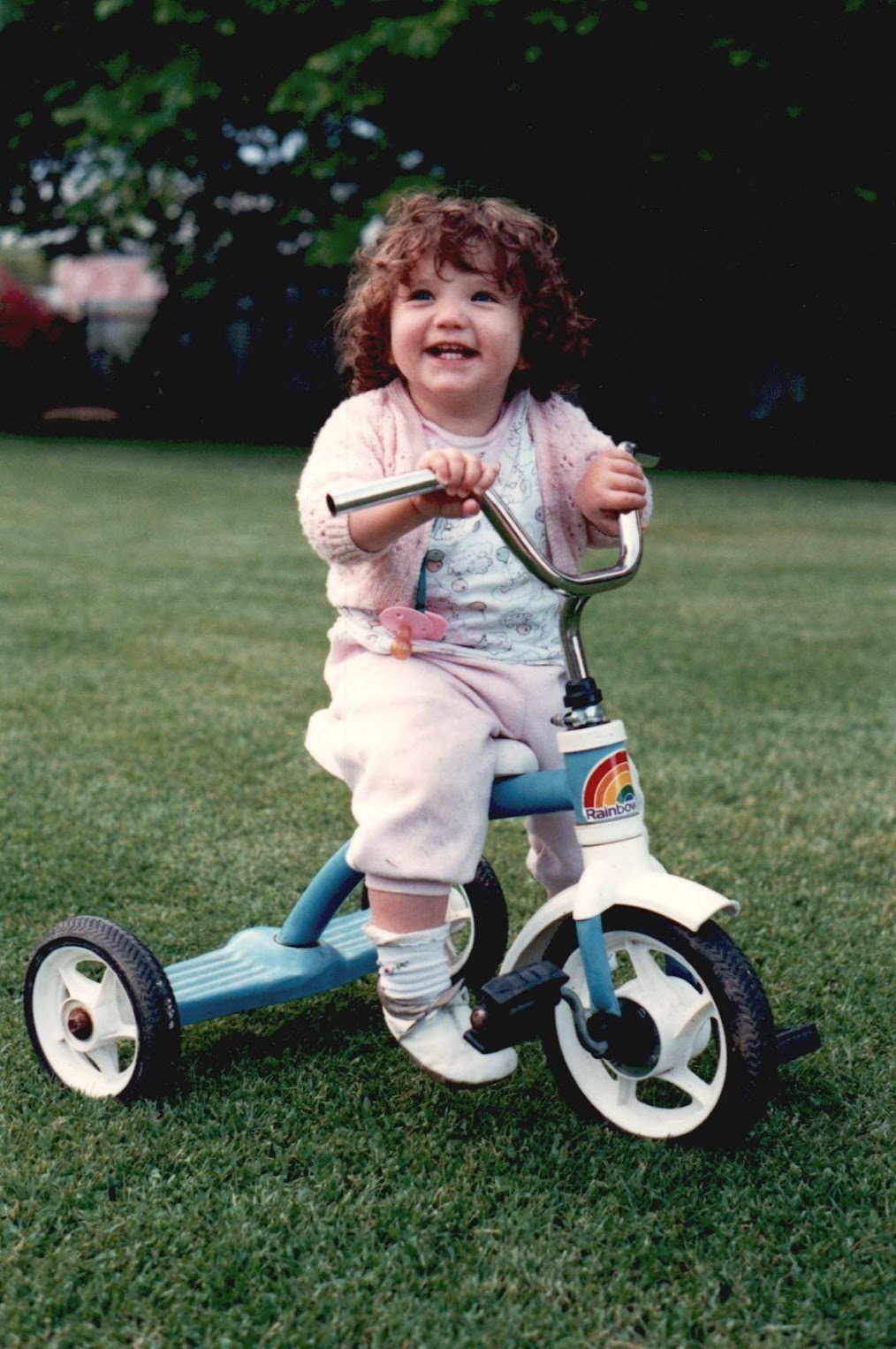 Young Caity on a tricycle